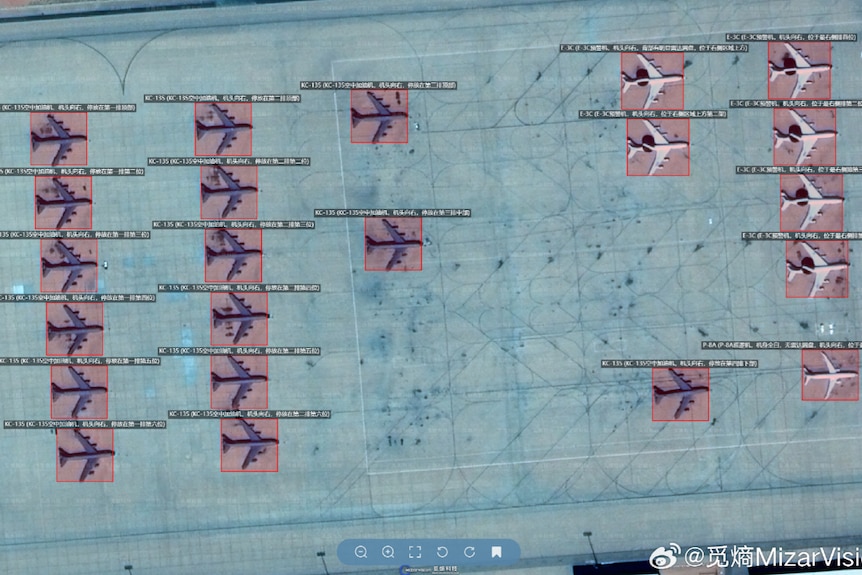 A satellite image showing military planes in rows in a desert area.