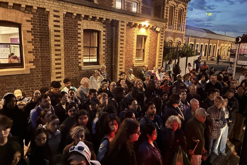 People gathered at a railway station.