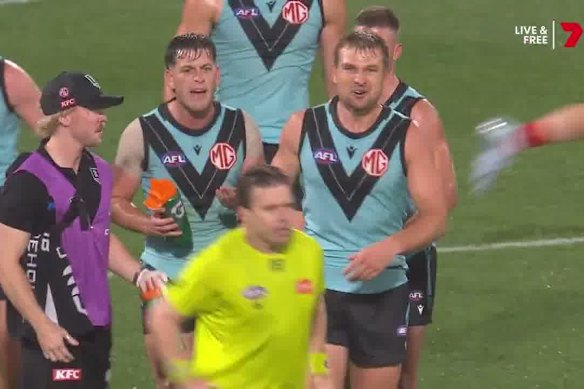 Zak Butters and other Port Adelaide players clash with the umpire.