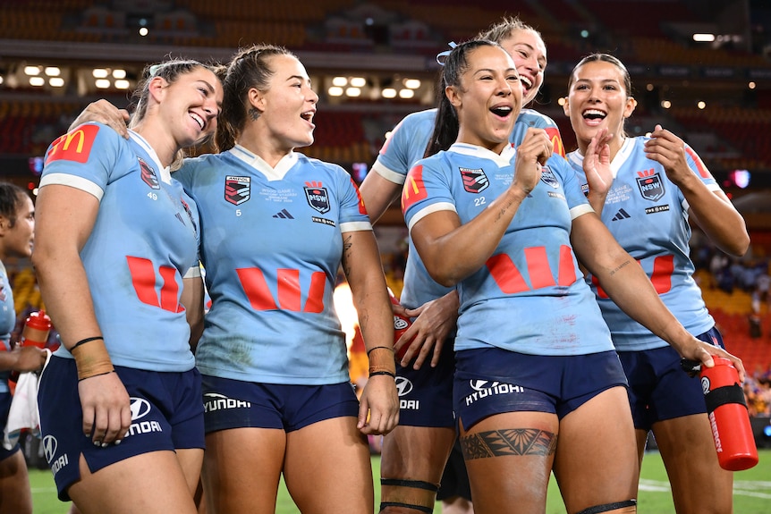 Jocelyn Kelleher, Isabelle Kelly, Tiana Penitani, Kezie Apps and Shaylee Bent smile after winning State of Origin I.