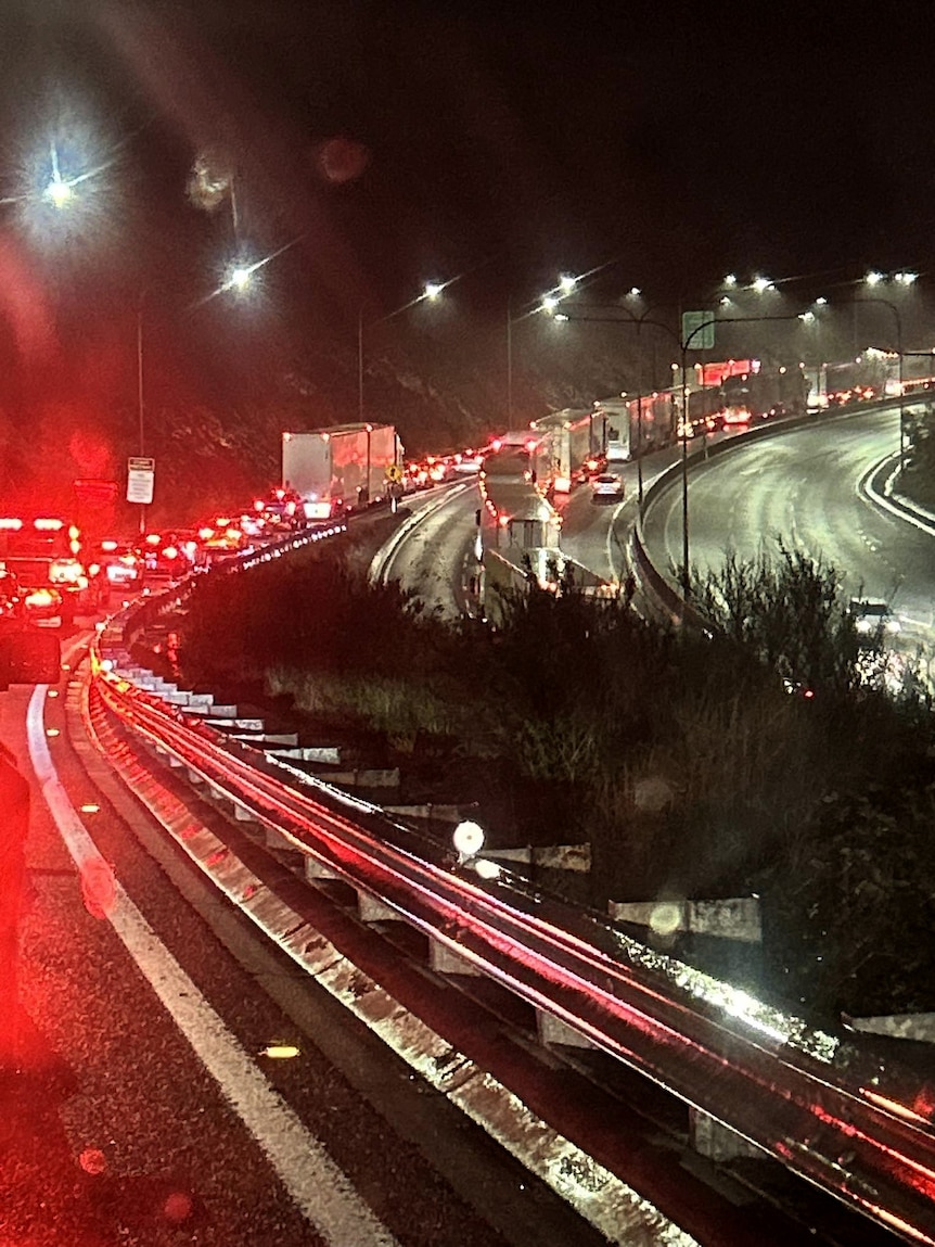 Access ramp to gridlocked freeway filled with cars