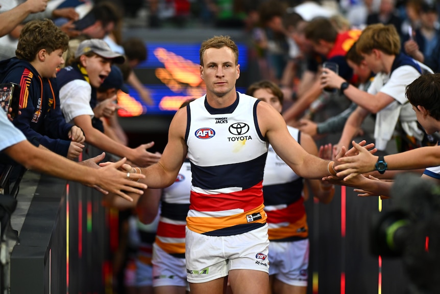 Jordan Dawson walks out between Adelaide fans