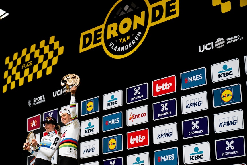 Demi Vollering and Tadej Pogačar with their Tour of Flanders trophies.