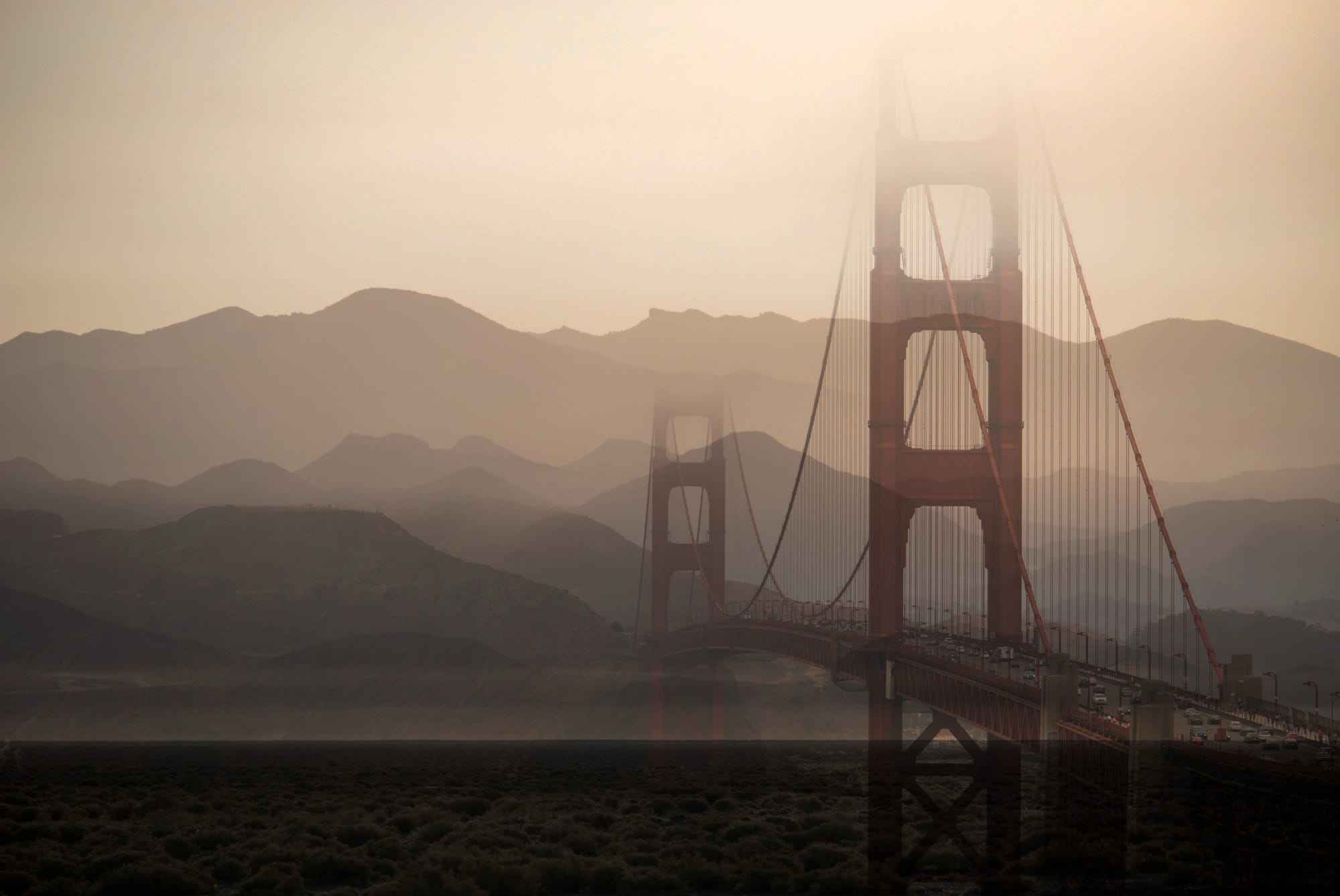 two photographs digitally superimposed, like a double-exposure, depicting the Golden Gate Bridge and hazy mountains