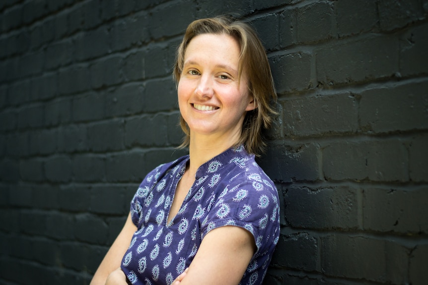 Leslie Martin standing against a brick wall in a profile photo, date unknown.