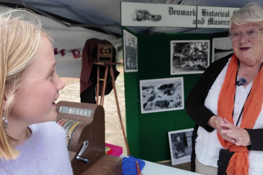 A woman talks to a young girl