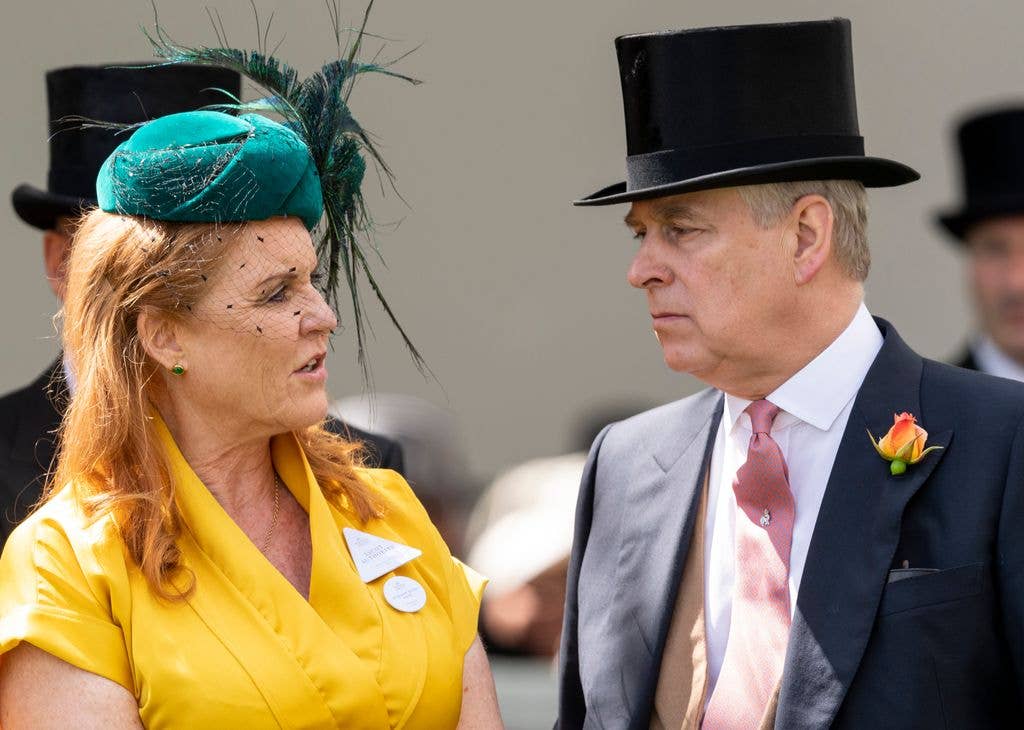 Andrew in top hat and Sarah Ferguson in yellow dress talking to eachother 