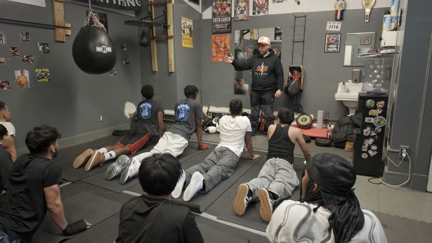 Boxing coach Mike Figueroa trains students at ATLAS High School.