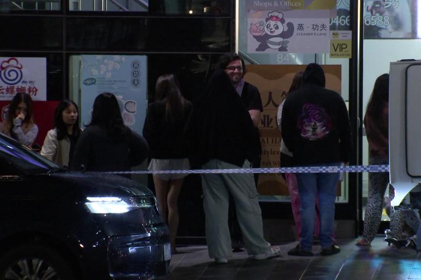 Residents waiting outside a Box Hill tower during the night