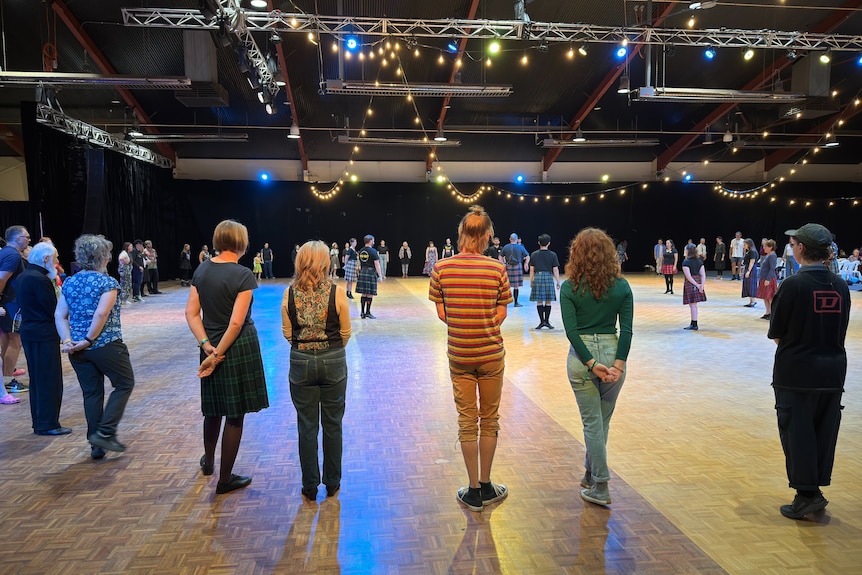 People dancing in a hall. 