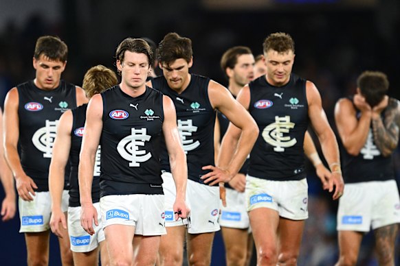 Dejected: Sam Walsh and the Blues trudge off Marvel Stadium.