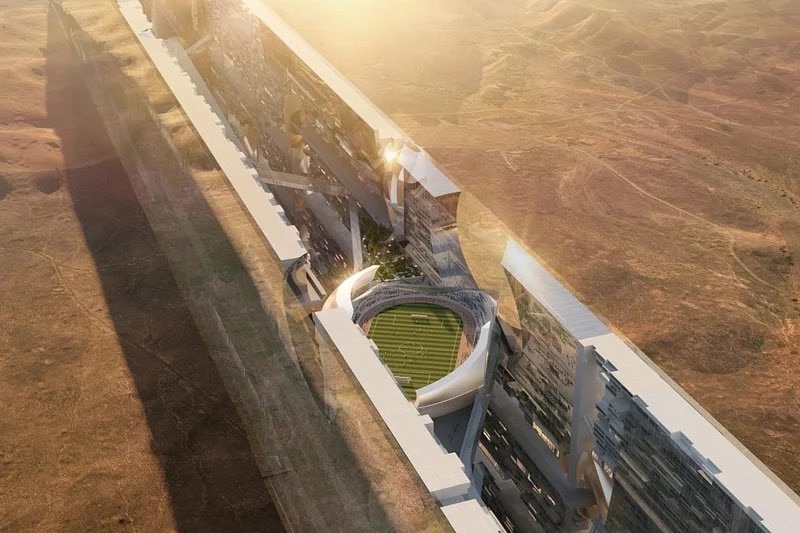 A futuristic building in the desert seen from above