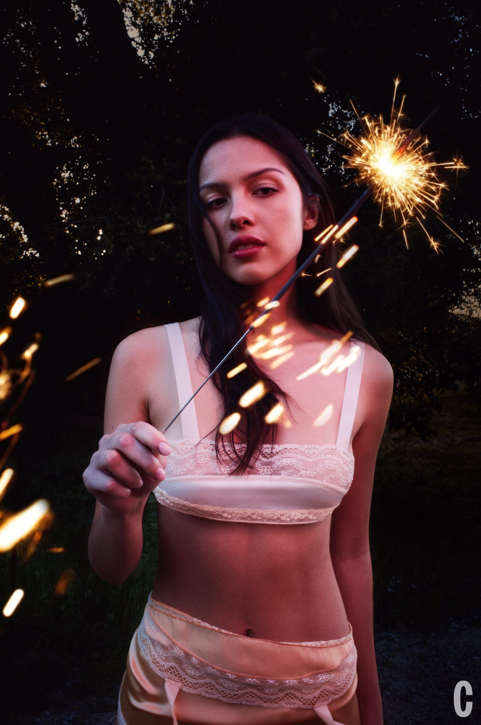 Person holding a sparkler in a dark outdoor setting. Person holding a sparkler in a dark outdoor setting.