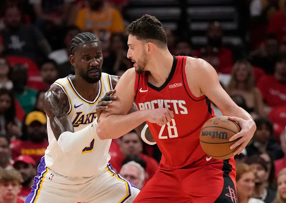 Houston Rockets center Alperen Sengun (28) controls the ball against Los Angeles Lakers center Deandre Ayton (5) during the first half in Game 4 of a first-round NBA basketball playoffs series, Sunday, April 26, 2026, in Houston. (AP Photo/Karen Warren)