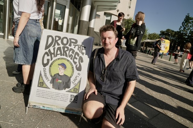 a man kneeling down outside court