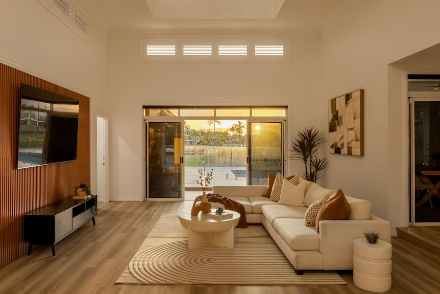 A luxurious lounge room opening out onto a pool.