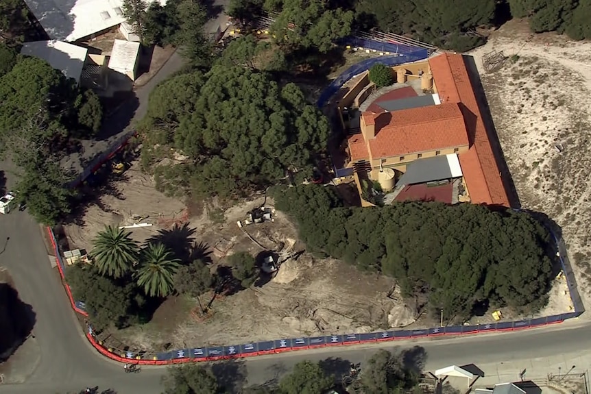 A police vehicle parked on a building site. 