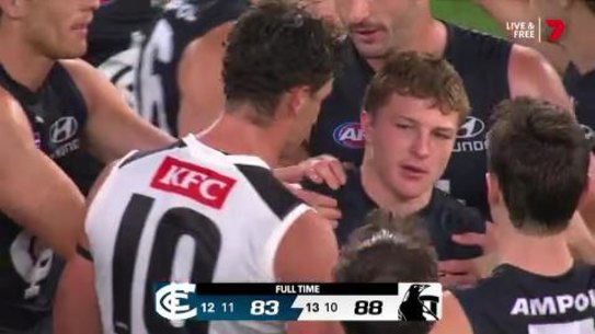 Talor Byrne is consoled by Carlton and Collingwood players, including Scott Pendlebury.