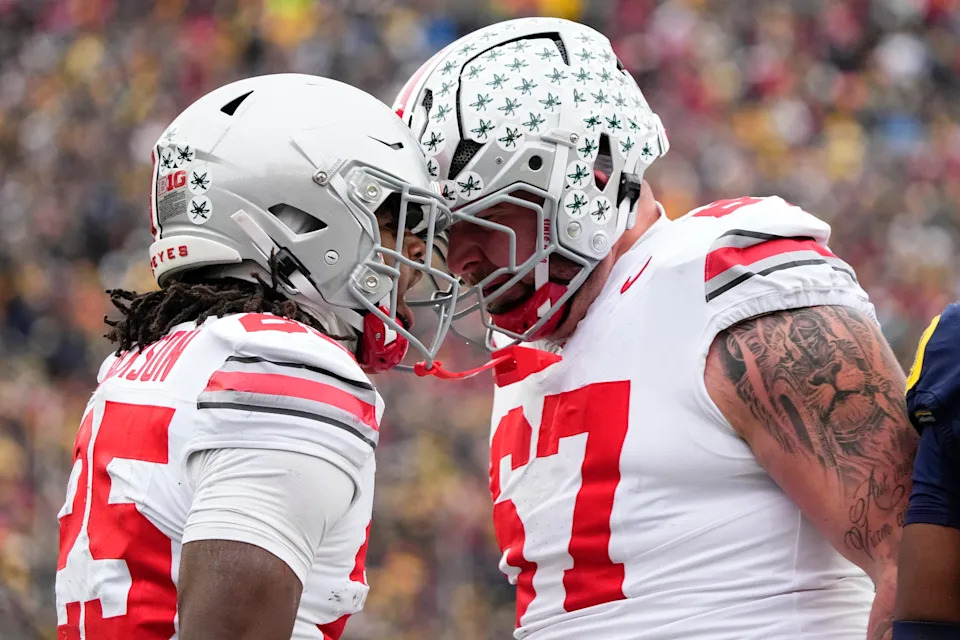 Ohio State Buckeyes offensive lineman Austin Siereveld (67) celebrates a long run by running back Bo Jackson (25) during the NCAA football game against the Michigan Wolverines at Michigan Stadium in Ann Arbor, Mich. on Nov. 29, 2025. Ohio State won 27-9.