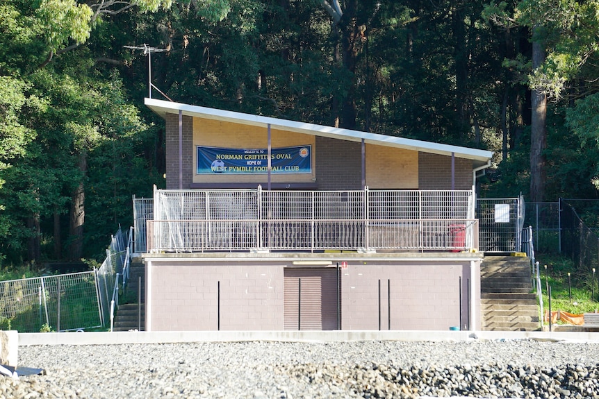 a football clubhouse surrounded by temporary fencing