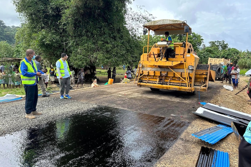 A grader lays bitumen for a new road.