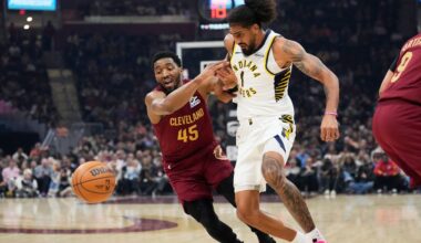 Cleveland Cavaliers guard Donovan Mitchell (45) knocks the ball away from Indiana Pacers forward Obi Toppin (1) in the first half of an NBA basketball game in Cleveland, Sunday, April 5, 2026. (AP Photo/Sue Ogrocki)
