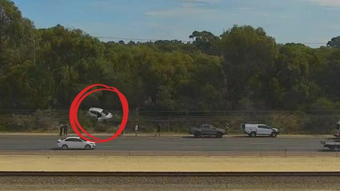A crash has caused lane closures, with vision from the scene showing a white hatchback in bushland next to the freeway. 