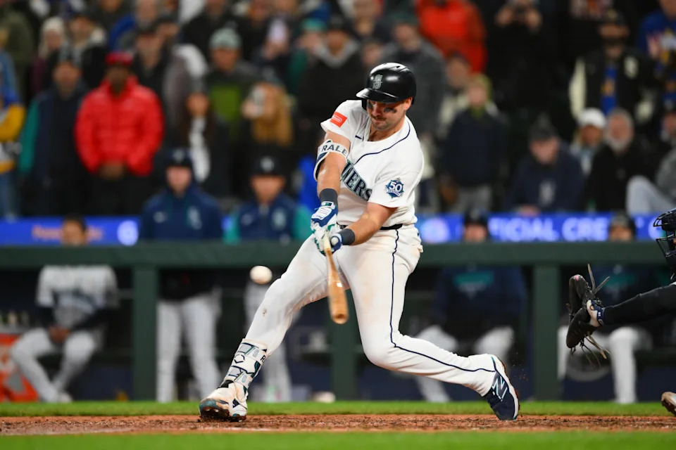 Apr 1, 2026; Seattle, Washington, USA; Seattle Mariners catcher Cal Raleigh (29) hits a RBI single against the New York Yankees during the eighth inning at T-Mobile Park. Mandatory Credit: Steven Bisig-Imagn Images