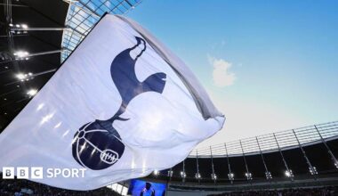 A white flag with a Tottenham Hotspur crest on it