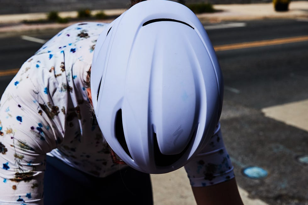 BKE Cyclist wearing a white helmet while focusing on a task.