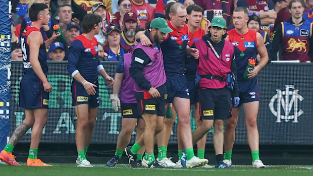 Harrison Petty of the Demons leaves the field with trainers.