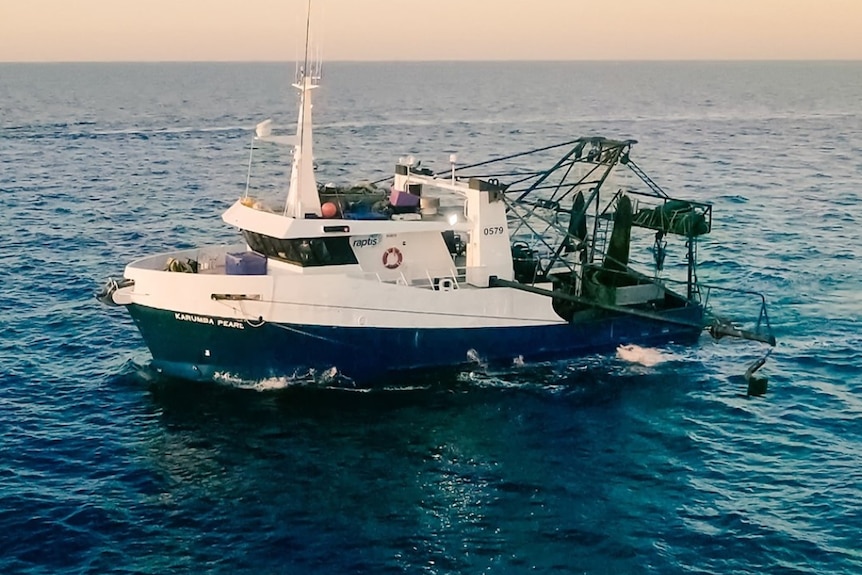old photo of a raptis boat in the water.