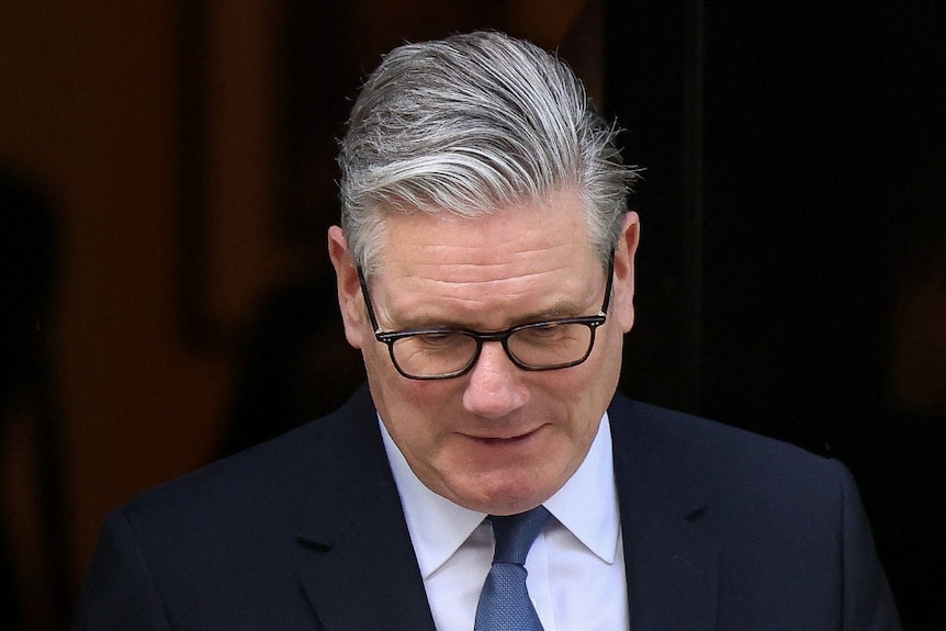 A man in a suit looking down