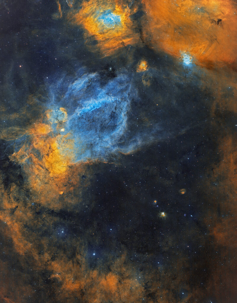 Large clouds of interstellar gas and dust of various shapes and sizes cover the image. A cloud shaped like a bubble 
sits atop the image, while a cloud shaped like a claw is in the middle.