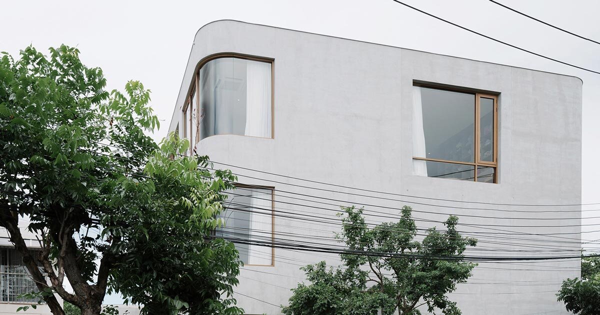 oom house’s curved concrete volumes interlock through glass hinge