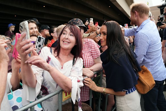 Fans waiting to catch a glimpse of Prince Harry and Meghan in Sydney on Friday had not a care in the world over if the duke and duchess are officially working royals. To them, the effect was the same.