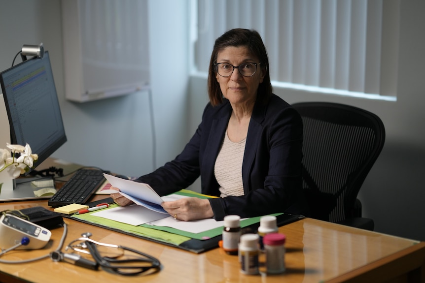 A woman sitting at a desk.