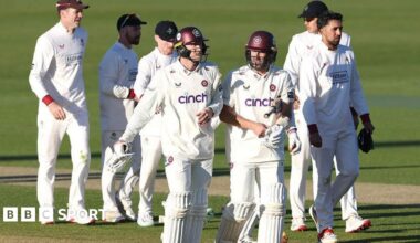 George Bartlett and Ben Sanderson walk off with Lancashire players behind