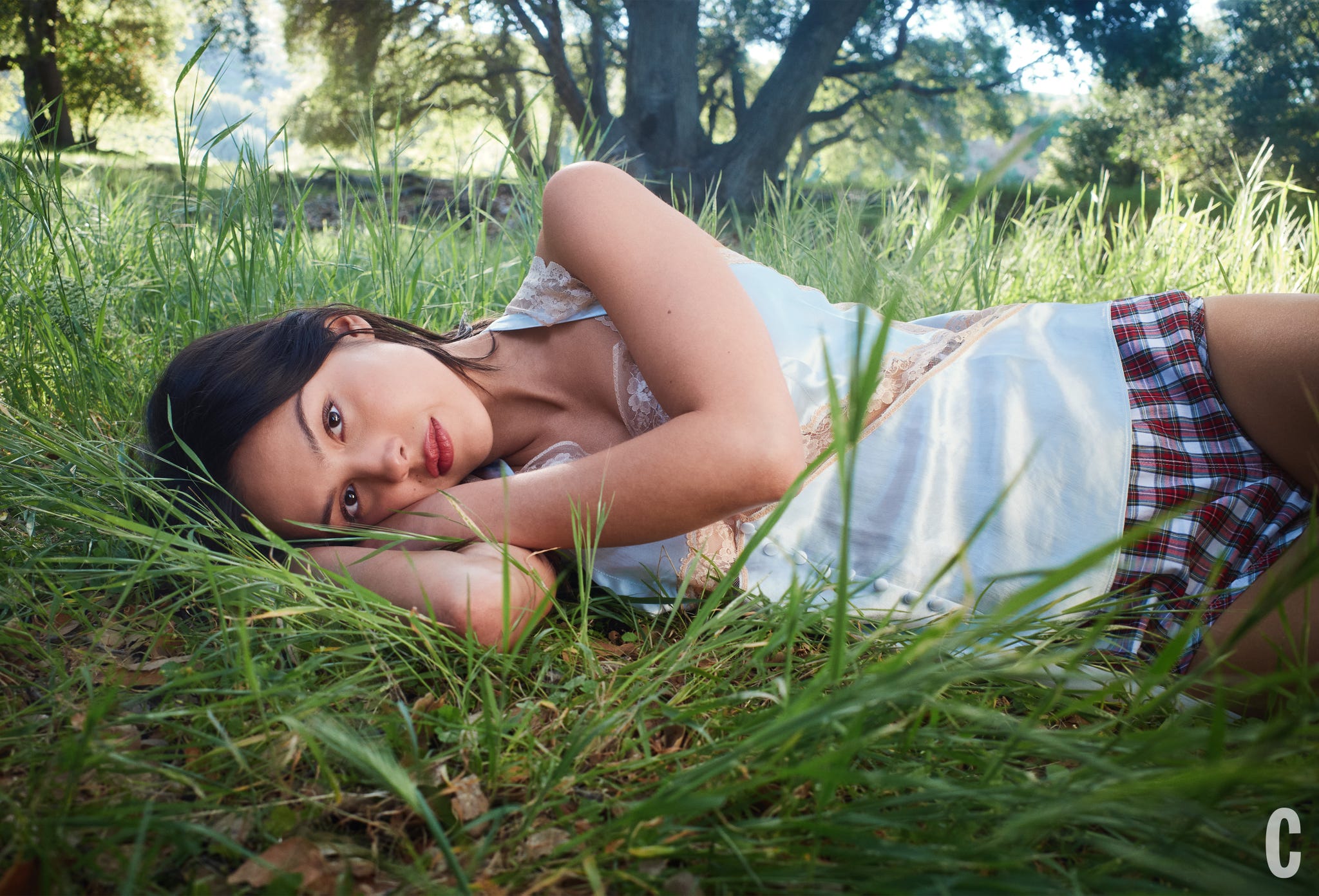 A person lying in a grassy area, seemingly relaxed. A person lying in a grassy area, seemingly relaxed.