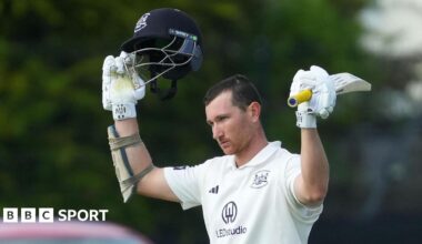 James Bracey raises the bat after his century for Gloucestershire against Lancashire