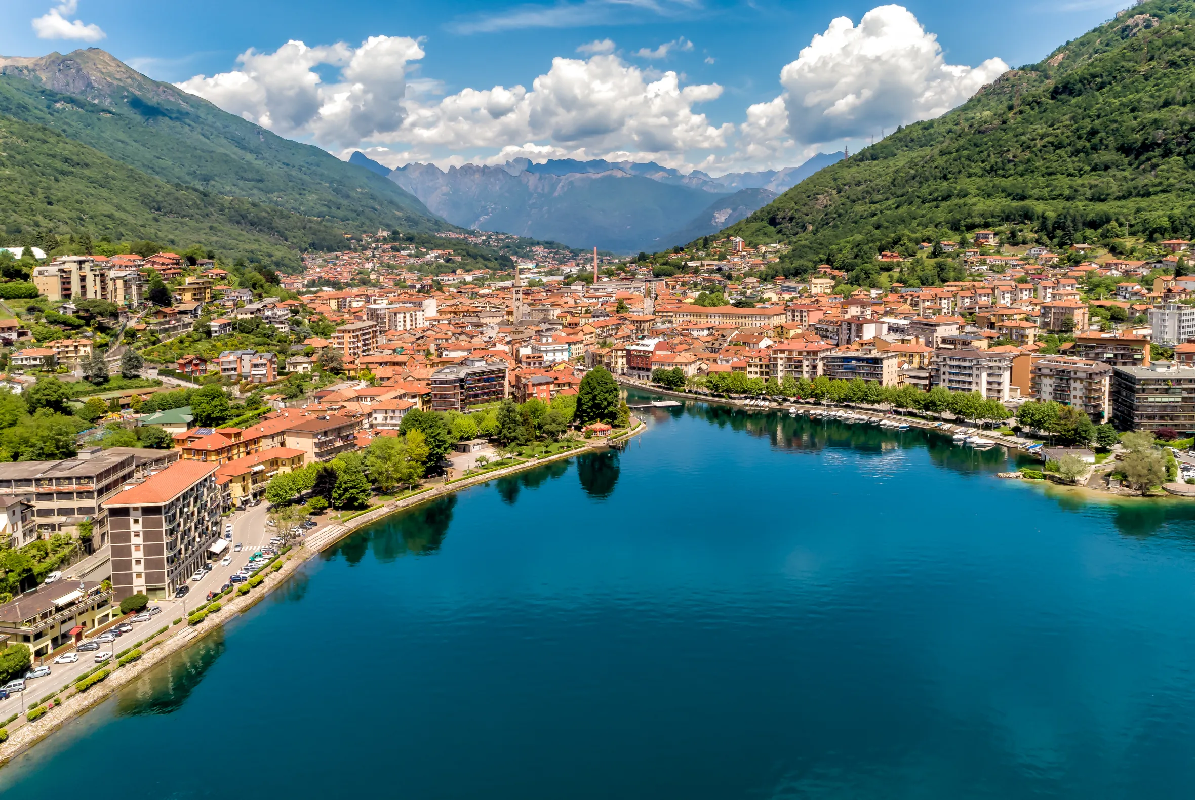 Aerial view of Omegna on Lake Orta, Italy, with mountains in the background.