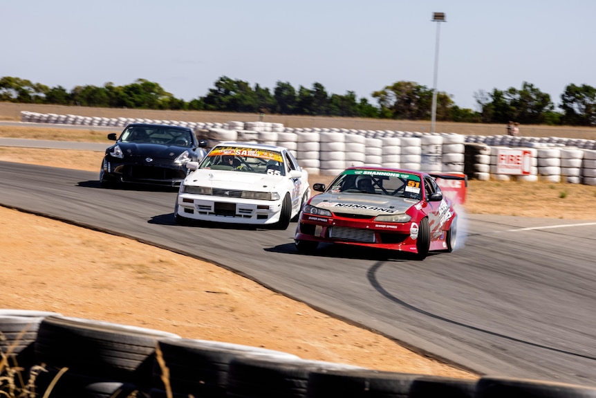 Cars racing on a track.