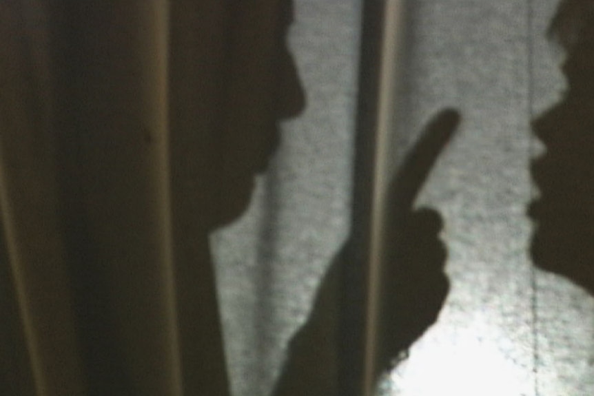 A close up of the shadow of a man and woman arguing 