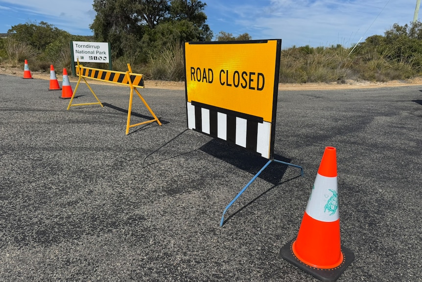 A road close sign is seen on a street.