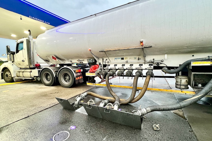 Petrol delivery truck at service station.