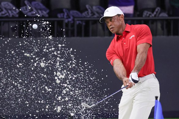 Tiger Woods hits a practice shot from a bunker in his last televised golf event on March 24.