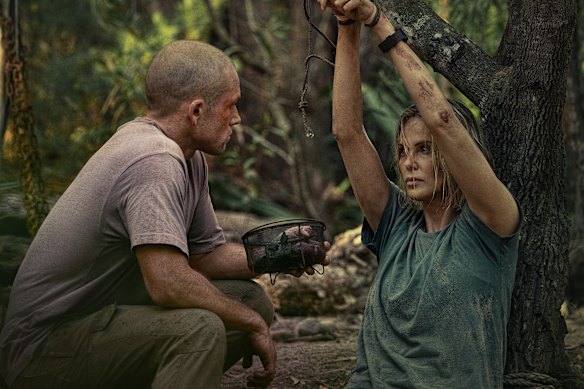 Taron Egerton as Ben, who turns hunter, with Charlize Theron as Sasha, his prey.