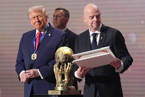 US President Donald Trump receives the FIFA Peace Prize from FIFA president Gianni Infantino during the draw for the 2026 soccer World Cup.