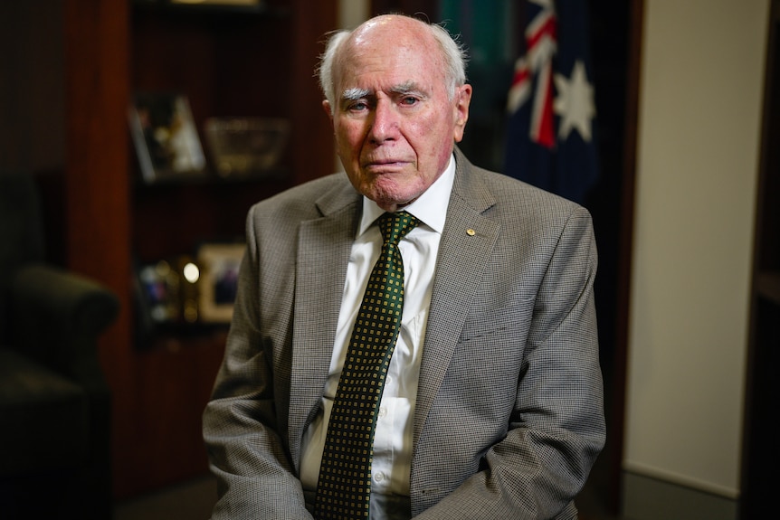 An elderly man in a suit