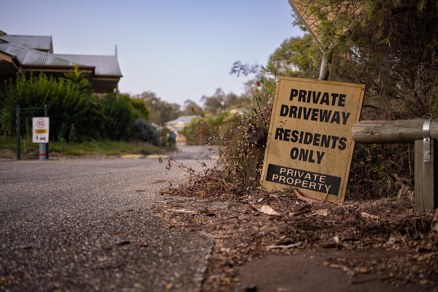 A sign in a driveway